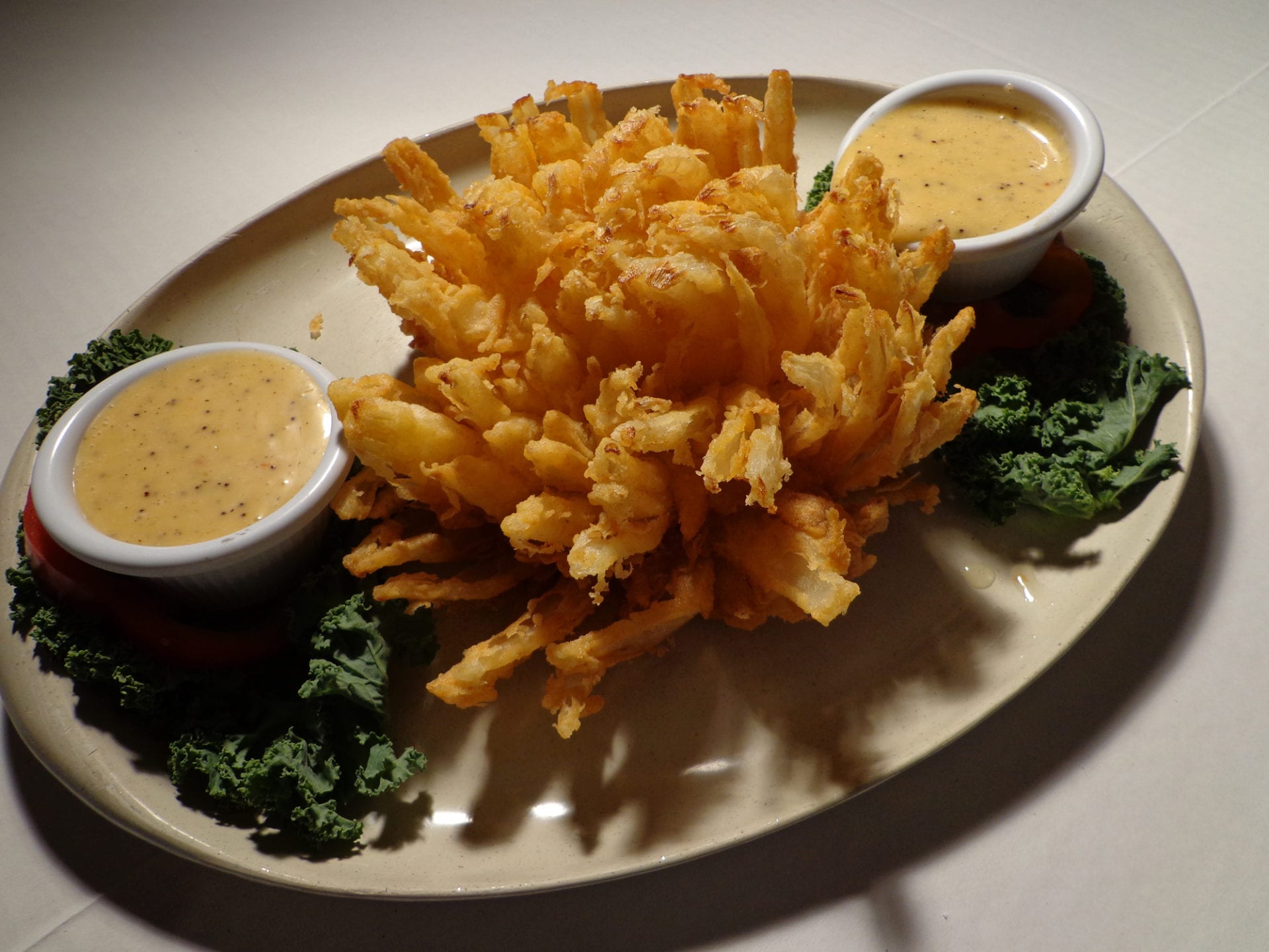 A Blooming Onion With Sauce Dips