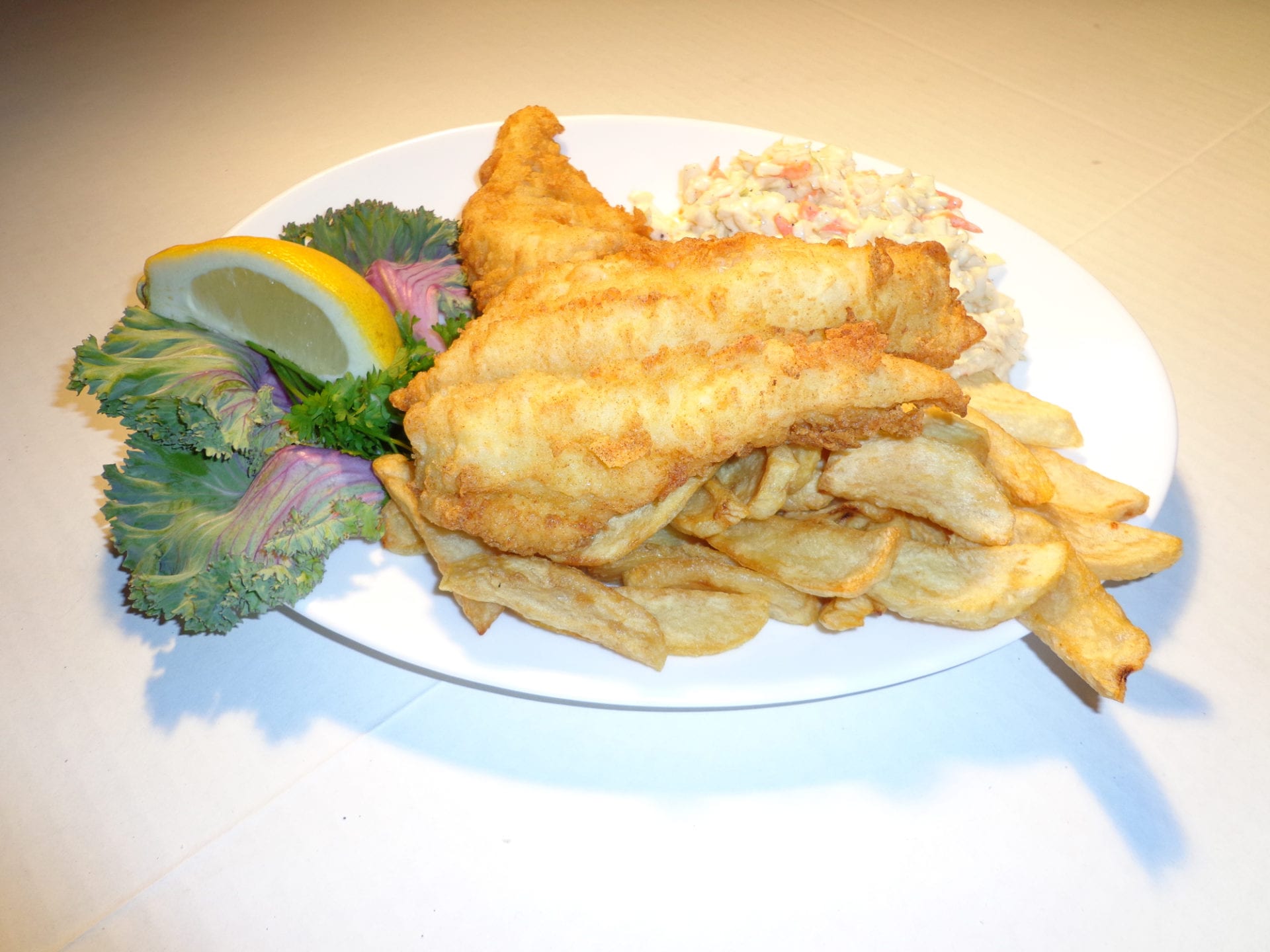 A Fried Fish Slice With Chips on a Plate